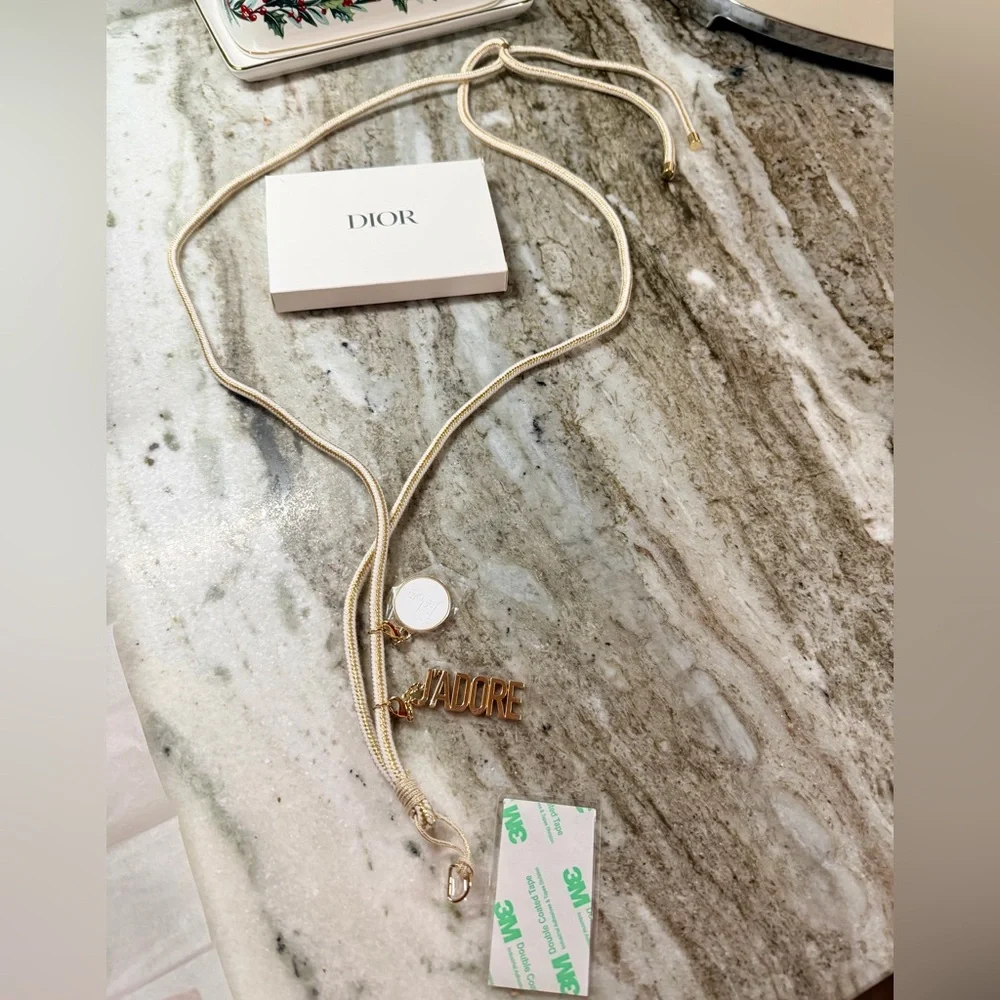 Dior J’adore Phone Strap with Charms. Measures 22” long. New in Box. Sealed